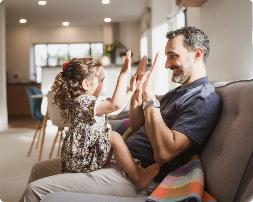 Dad and daughter sitting on couch