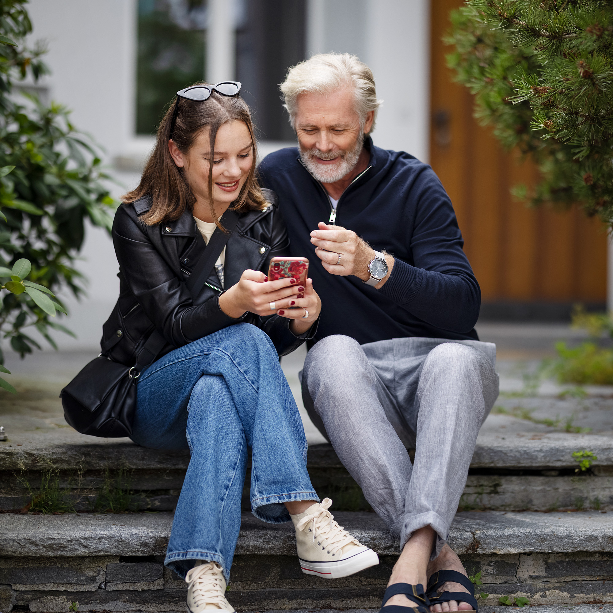 Junges Fräulein und Herr schauen zusammen auf ein Smartphone